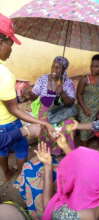 Our team member sharing food items to the women