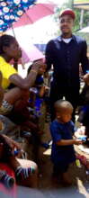 Our Project Leader giving biscuits to the children