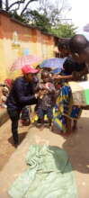 A child receiving food items for his mother