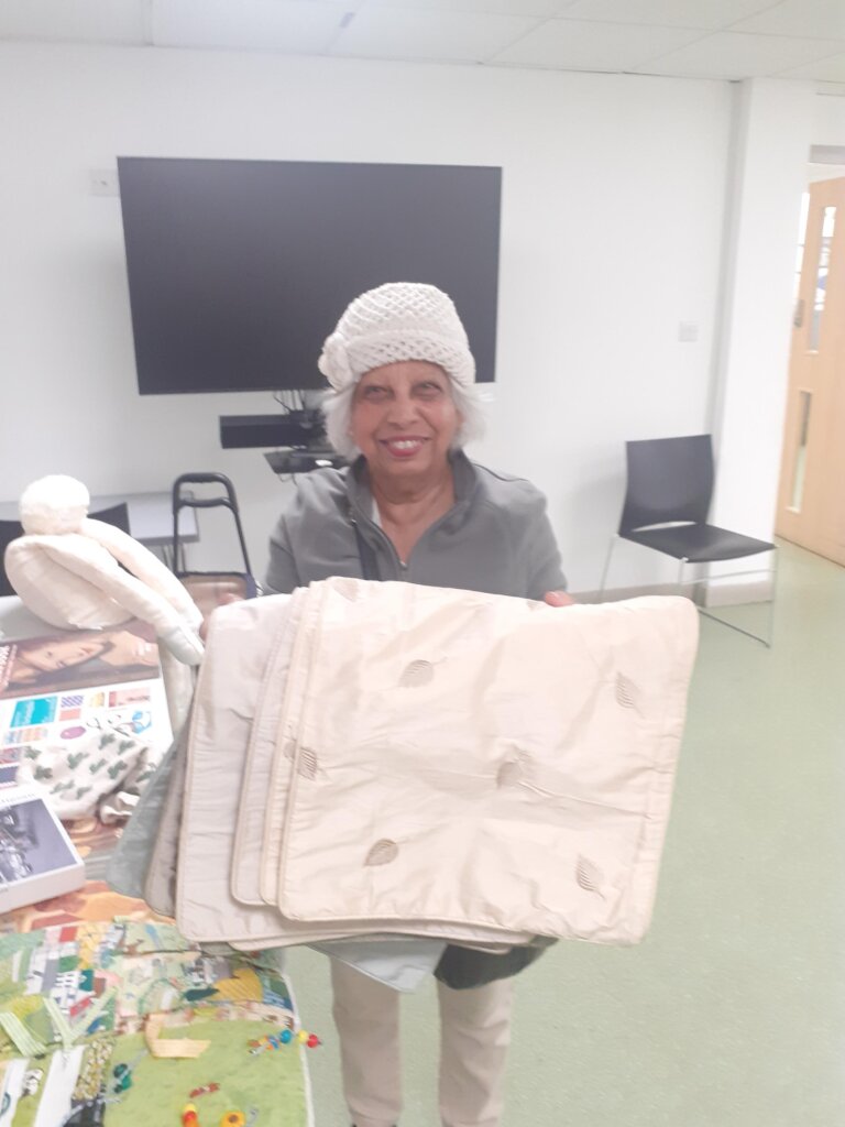 Carer Chandra with silk cushion cases she made