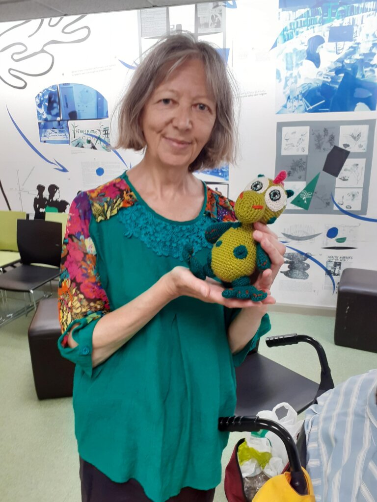 Carer Elena with a cuddly toy she has knitted!