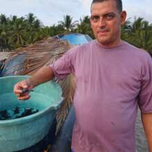 Reuben holds baby turtle before release