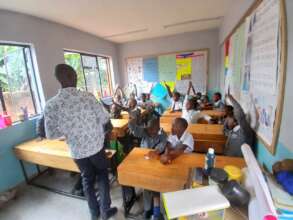 Teacher George reading with his students in Grade3