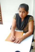 Mitra Jyothi Beneficiary Reading Braille book
