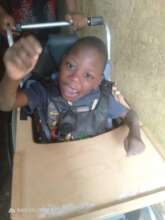 Our program client receiving a wheelchair.