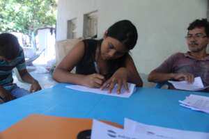 Yosselin signing her scholarship contract for 2023