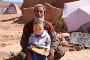 Ajmal and son Mohib, 4 in front of a shelter.