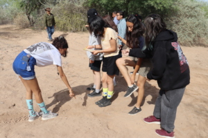 Identifying wildlife tracks on El Castor Trail.