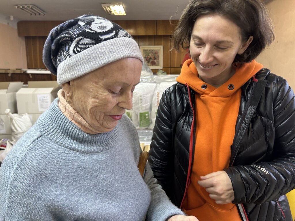 (Peace Winds staff listening to evacuee's stories)