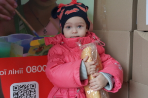 Milana* receives a loaf of bread.