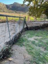 Mountains of sand banked up against gates & fences