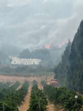 A water cart and tractor en route to  fire