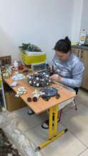 A Ukrainian woman creating Christmas decorations