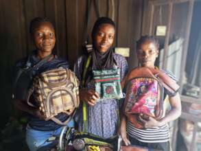 Women showcasing their handwork, bags they produce