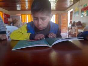 Child reading at the library
