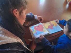 Teacher helping a child with reading