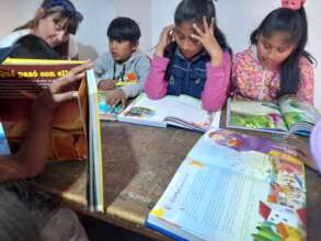 Kids reading at the project