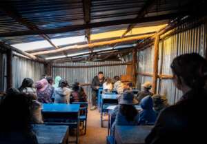 Children gathered in a small classroom, enjoying t