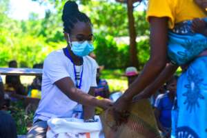 Midwife Robline delivering food after cyclone