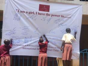Girls adding responses to the IDG banner