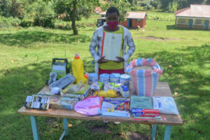 An eighth grader with her Angaza care package