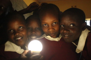 Our girls admire a new solar-powered lightbulb
