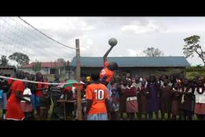 KCE volleyball player jumping to score a point