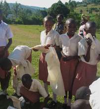 Girls receiving their new uniforms