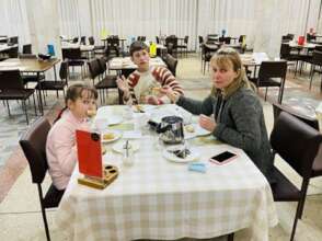 Mom, Olga eats w/her 2 children incl. autistic son