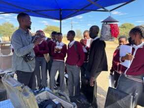 Students learn about elephant research equipment.