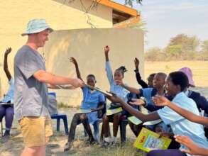 David handing out educational materials.