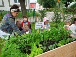 Young kids in their thriving spring school garden