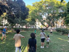 children and volunteers playing during the summer