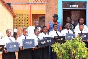 students holding laptops