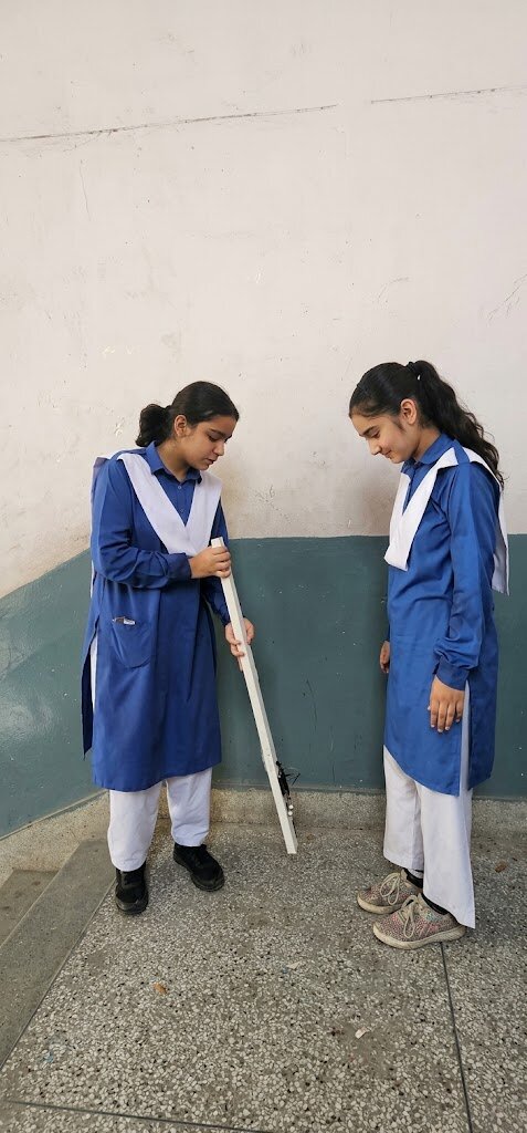 Halima and Mehrab testing the blind stick
