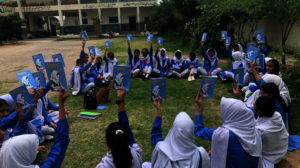 Students holding their copies of Tehreer