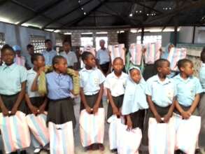 childrens recieving sanitary towels from the NGO