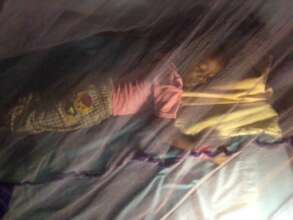 Gracious sleeping under a mosquito net