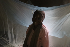 Haja sitting under her bed net