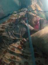 Joseph showing how he sleeps under his net