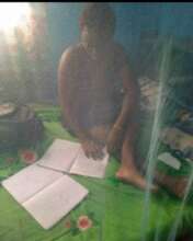 Magdalene studying under her bed net