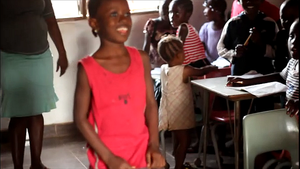 Happy Rugiatu playing with her friends