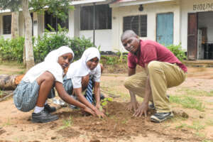 Students and staff join hands in tree planting