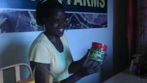 Attendant at AF shop marketing cow peas leaves