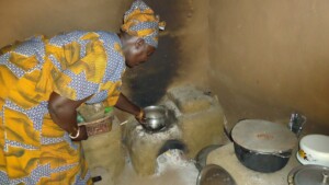 Mrs E. cooking with own built energy saving stove
