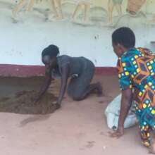 Using cow dung to seal lunch shed floor