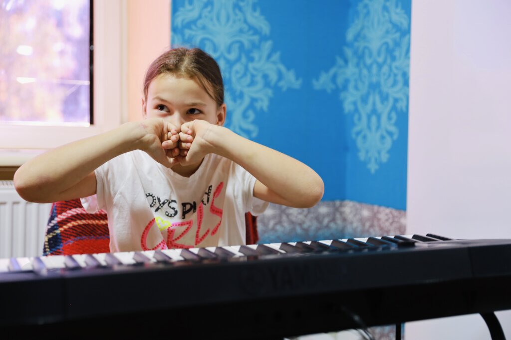 Tanya with her real piano, Refugee Center Moldova