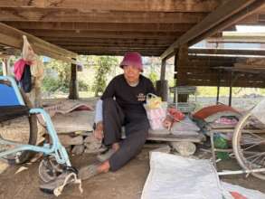 Sitting under a traditional Thai farmhouse