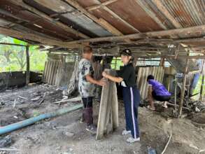 Staff and Students on term break prep new shed