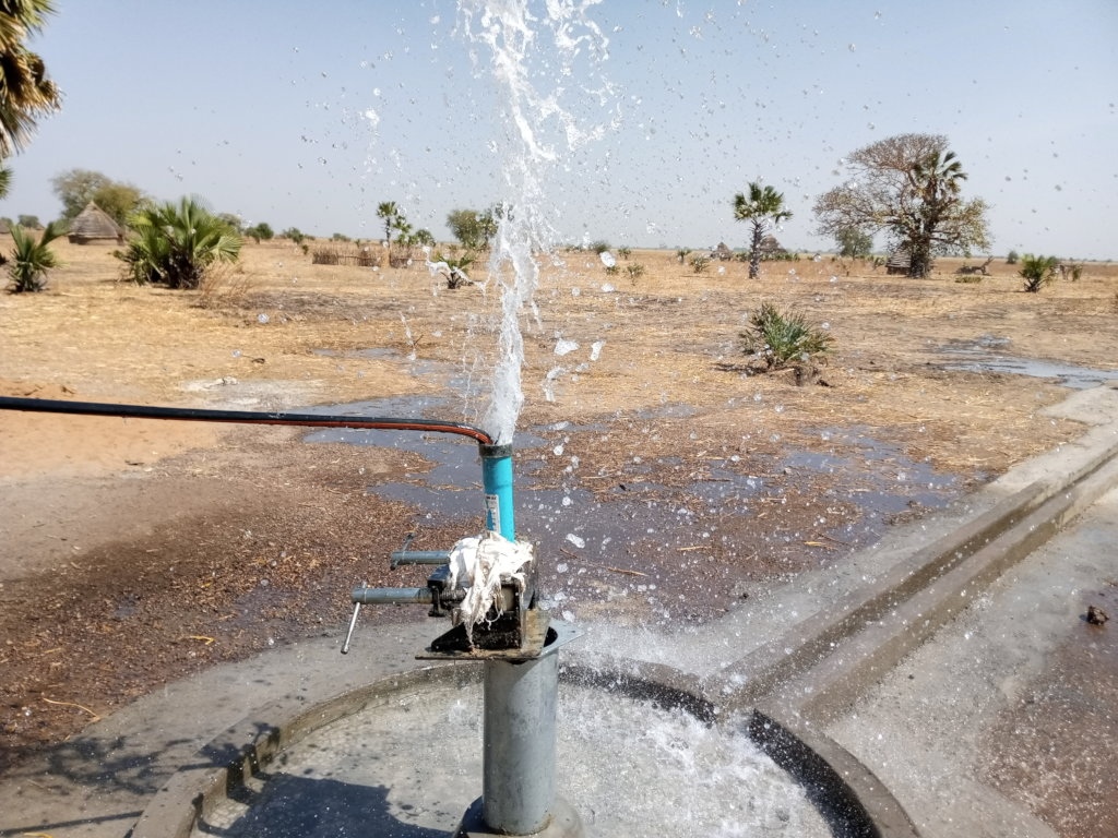 Water sprays from a newly constructed well